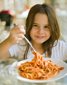 child having spaghetti